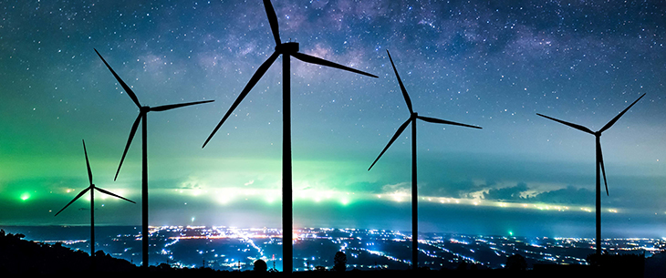 wind turbines at night with northern lights
