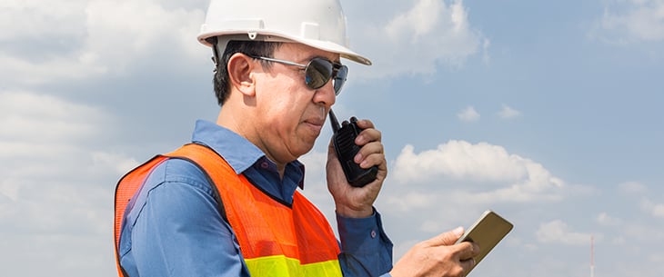 field worker answering radio call