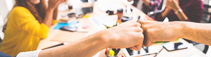 Utility Network Migration - Success Stories team collaboration concept with fist bump