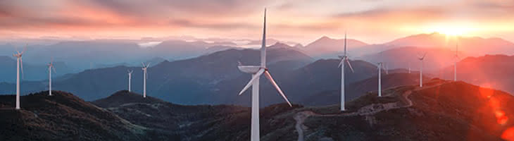Sunset over the mountains, with windmills